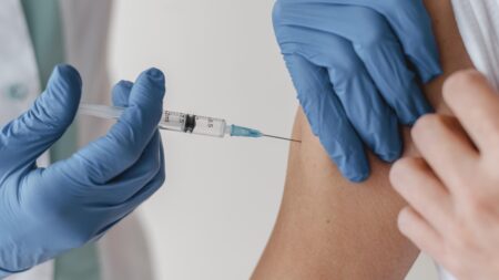 doctor with gloves vaccinating patient