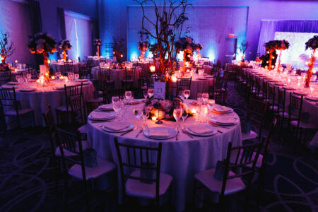 decorated wedding hall with candles round tables and centerpieces 1